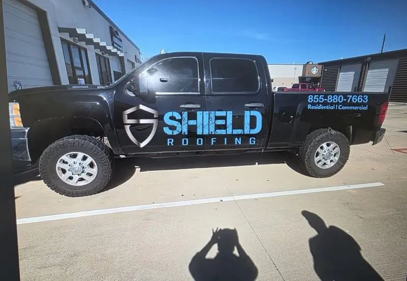 Black pickup with roofing company door graphics, by ExpressAutoTNT in Katy, TX
