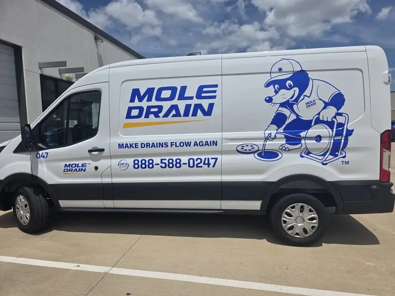 White cargo van with commercial vinyl graphics for a drain-cleaning company, done by ExpressAutoTNT in Katy, TX
