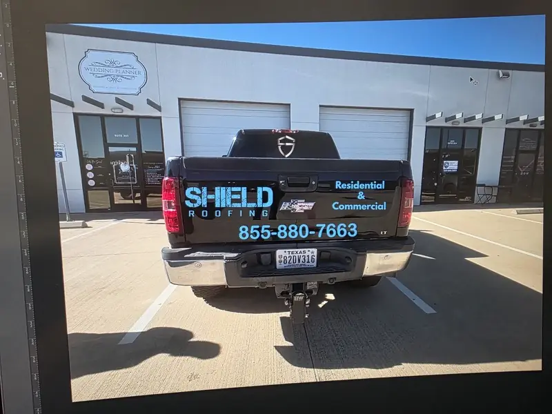 Rear of a black pickup with roofing company tailgate graphics, by ExpressAutoTNT in Katy, TX