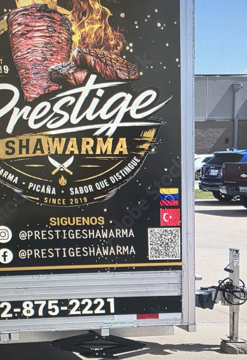 Close-up of a food trailer’s printed graphics with social handles and a QR code, Katy, TX