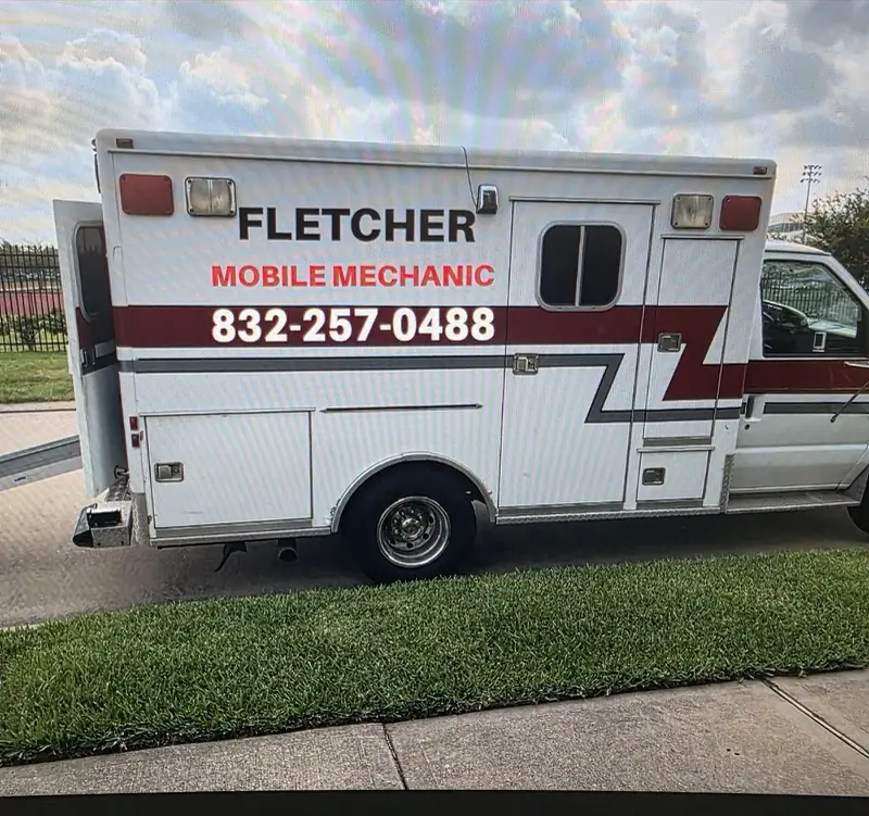 Side of a box truck with red stripes and mobile mechanic lettering, Katy, TX